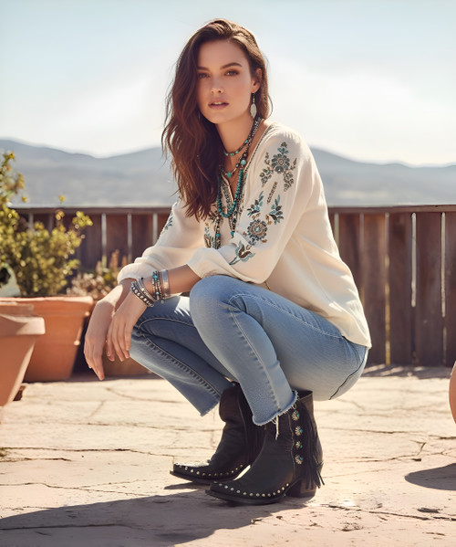 Step up your boot game with this season’s popular mid-calf length. Double D Ranch’s Apache Kid Boot adds a few more inches, a little more coverage, and a lot more style points.  Hand crafted in calfskin with contrast trim and sassy fringe, but it is the turquoise studded conchos that take this boot over the top.  

 

Features:

Toe: snip 

Leather: calfskin with suede contrast

Heel: tall riding 

Nail heads

Navajo style conchos

Self-lacing and fringe