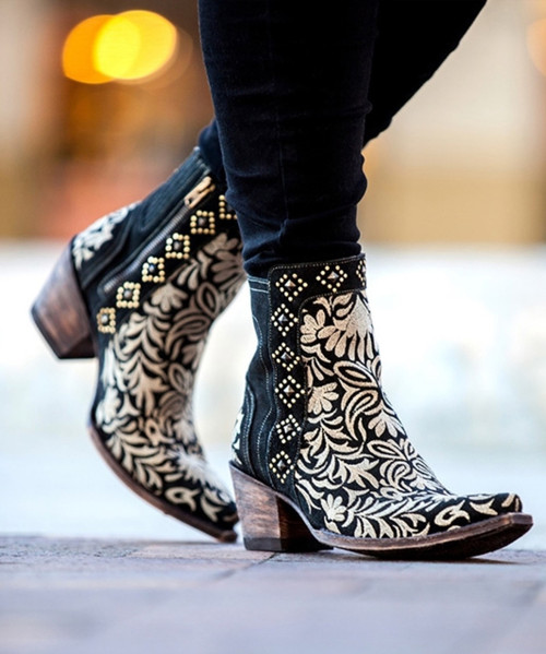 The Old Gringo Boot company is unmatched when it comes to cowgirl boots featuring floral embroidery.  It's no wonder we fell in love with Wink.. You'll love the black leather, the off white thread, and chic stud work. Interior side zippers add extra convenience, and the higher boot heel gives off a classy country look. The Old Gringo Wink Boots in black are fierce and flirtatious!

Measurements:

Shaft Height - 7"
Heel Height - 2.75" 
Toe - 4L (Snip)