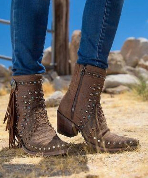 Here is your ultimate multi-tasker for work or play – this lower-calf boot adds a biker’s edge to your wardrobe, ups your boho dressing game, and adds a bit of bling to your step. Our Boogie Boot will be one of the most hardworking, hard rocking, pieces in your wardrobe.

Toe: snip toe
Leather: rough-out leather and rough embossed croc
Heel: tall riding
features: nailhead and crystal trim, contrast leather lacing, turquoise studded concho and suede fringed tassel, inside zipper, inside elastic goring for fit adjustment