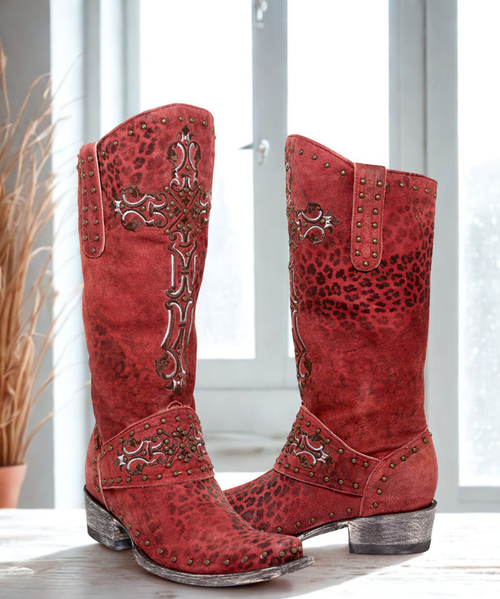 Turn Heads in the Old Gringo Women's Krusts 13" Red Leopardito Studded Leather Boots

Bold, beautiful, and undeniably eye-catching—the Old Gringo Krusts boots in Red Leopardito are designed to make a statement. Featuring a fierce leopard-print goat leather upper, these boots are accented with brass studs and an ornate Victorian-style embroidered cross that adds drama and elegance in equal measure.

The 13-inch shaft is finished with tooled leather overlays on the cuff and toe, bringing artisanal detail to a rebellious silhouette. Inside, supple leather lining offers all-day comfort, while the premium leather sole and footbed ensure durability that matches their daring style. The Southern toe and Hippie Dama heel create a flattering, feminine shape that transitions effortlessly from day to night.

A fiery, fashion-forward addition to your boot collection—these are not just boots, they’re conversation starters.