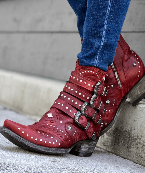 The distressed Vesuvio red leather, buckle accents, and silver stud work is an over-the-top fashion statement. These beauties are finished off with interior side zippers, a snip toe, and easy walking heel.
