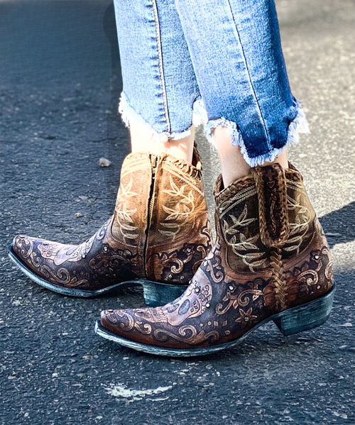 We loved the Old Gringo Klak but also the Polo Chale so why not have the best of both worlds!  Introducing the EXCLUSIVE Boot Junky Old Gringo Klak crystal boots with the Polo Chale hand tooled flair.

This boot has it all!  The distressed natural leather boots with black etched hand tooled sugar skull on the toe and shaft are over the top. The best part of course are the Swarovski crystals.   Not only will you look bad to the bone in the Old Gringo Klak Boots, but you'll also sparkle and shine the whole time.  The shorter boot shaft makes them great for any season or reason - easily worn with jeans or dresses! You'll be comfortable all day in the traditional heel and snip toe.  

Measurements:

Shaft Height - 7"
Shaft Opening - 12"
Heel - 9964 (traditional)
Toe - snip