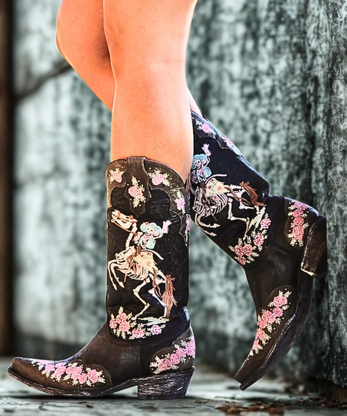 The Old Gringo Ghost Rider Boots, inspired by the Dia De Los Muertos Holiday in Mexico, are full of personality.  The distressed black and gray leather is decorated with a skeleton cowgirl on her skeleton horse rearing up for a big ride. Pink floral embroidery and small studs also accent these super cute cowgirl boots. The distinctive artwork and intricate design of the Old Gringo Ghost Rider Boots make them the ultimate conversation piece! 

Measurements:

Shaft Height - 13"
Shaft Opening - 14"
Heel - Hippie Dama (1.75")
Toe - Southern