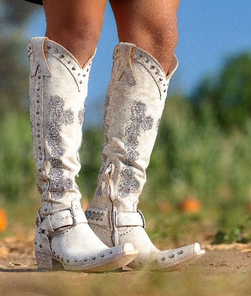A Little Bit of Country + A Little Bit of Rock & Roll.  Embellished with crystals, studs and embroidered rose in silver, finished off with a metal ring harness with a buckle strap over the ankle. 

A piece of art, that's exactly what this boot is.

Hand placed silver studs, sparkling crystals and outstanding silver rose embroidered across the shaft, all come together against the signature Old Gringo Crackled white leather. Tall European Silhouette, Silver brush off finish on the sole; it's a boot like no other boot.  
