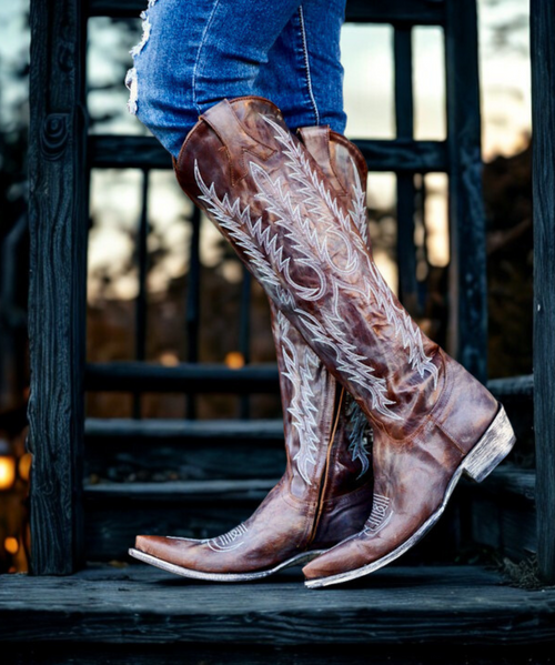 Boots are made for walking AND looking amazing and the Old Gringo Mayra Boots are SO on trend. These aren't just cowgirl boots, these are fabulous fashion boots. Handcrafted in Leon, Mexico with gorgeous distressed Baby Vesuvio Brass leather and accented with a blue finish and baby blue turquoise embroidery.

We love the tall, 18" silhouette and traditional snip toe of the Mayra Boots. 

Rock this boot all year around... we know you will look AMAZING and turning heads in these Boot Junky exclusive  Old Gringo Mayra Boots!

* Shaft Height - 18"
* Shaft Opening - 14.5" circum.
* Heel Height - 1 & 3/4" (9964)
* Toe - 4L SNIP
* Standard Width