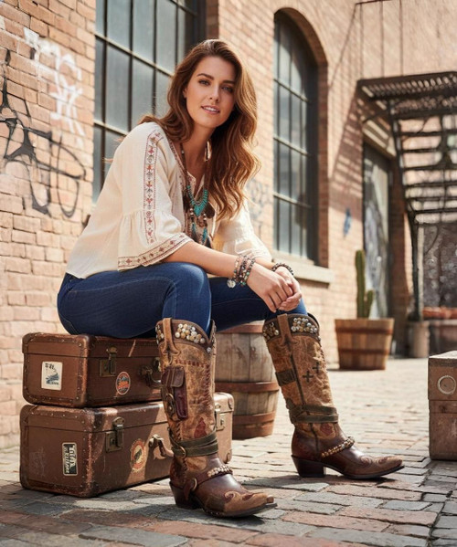 The Frontier Trapper Boot  has a rustic look with  the wear-and-tear holes and patching, which comes from a combination of 5 worn and perfectly distressed leather. The side-pocket and the bullet keeper on the back were an afterthought to the original design. Perfect for the modern-day "trapper gal" to store her cell phone, credit cards, and a little ammo.  Load'em up and get going!

