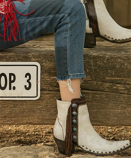 The Frontier Trapper Boot  has a rustic look with  the wear-and-tear holes and patching, which comes from a combination of 5 worn and perfectly distressed leather. The side-pocket and the bullet keeper on the back were an afterthought to the original design. Perfect for the modern-day "trapper gal" to store her cell phone, credit cards, and a little ammo.  Load'em up and get going!
