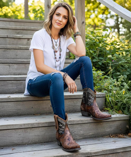 The Old Gringo Polo Chale with Distressed Black shaft styling... Featuring fabulous, intricate, floral hand tooling all over you'll love the shorter, 7" boot shaft, the easy walking heel, the leather braided accents, and chic rounded toe.