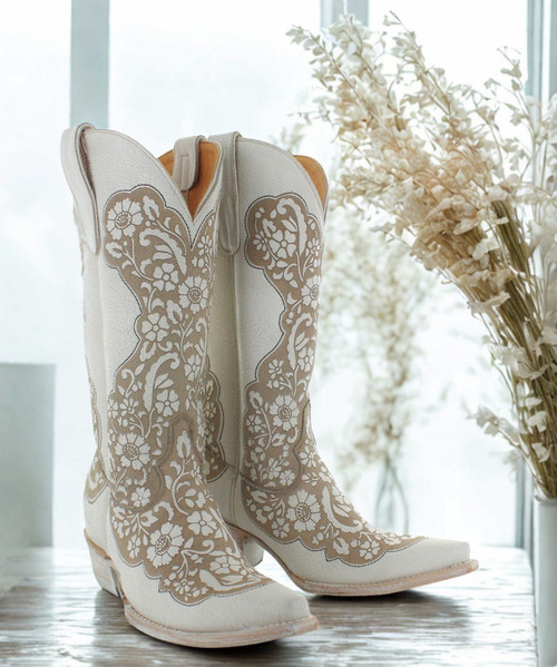 Another stunning pair of Old Gringo boots—the Migissi! These boots are a gorgeous blend of classy and country, making them an ideal match for any stylish cowgirl or someone looking for a unique touch to their wardrobe.

The laser-cut floral patterns on the taupe and bone leather give them a sophisticated yet rustic vibe. They have that perfect balance of elegance and edge that makes them versatile for different occasions.

 

The 13" shaft height and 1 3/4" walking heel make them both stylish and comfortable enough to wear for extended periods. The snip toe adds a traditional western touch, but it still feels fresh and modern with the laser-cut design. 

 

If you're considering these for a wedding or special event, they’d definitely be an unforgettable choice. Plus, the combination of taupe and bone is so neutral, they'd match with almost any color scheme.

 

Are you leaning towards these boots for a particular event, or are you just loving the style?

Measurements:

Shaft Height - 13"
Heel - 9964
Toe - Snip