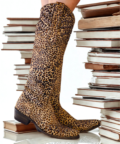 What can you say about a boot that will turn every head when you enter the room...we present the Old Gringo Leigh Ann Hair on Hide 18" boot as an exclusive from Boot Junky.
Constructed from rich colorful Cheetah print hair on hide leather, this boot features antique brass studs in various sizes, and styles along the shaft, cuff, and pull tabs of the boot. 