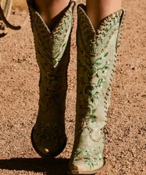 Designed as part of the Fall 2025 Wash House Collection, these cowgirl beauties bring the collection’s signature damask motif to life through intricate embroidery and refined stud detailing. The rich chocolate brown leather is beautifully balanced with icy blues and warm cream tones, while feminine floral accents add a touch of dainty elegance to this timeless Western silhouette.

Finished with a tall riding heel for a confident lift and a sleek snip toe for a refined profile, this 17" shaft boot blends classic cowgirl heritage with elevated, fashion-forward artistry.

Details:

Color: Chocolate

Embellishment: Embroidery & Studding

Heel: Tall Riding Heel (3.5")

Shaft Height: 17"

Toe: Snip Toe

A striking statement boot that captures the romance and craftsmanship of the Wash House Collection.