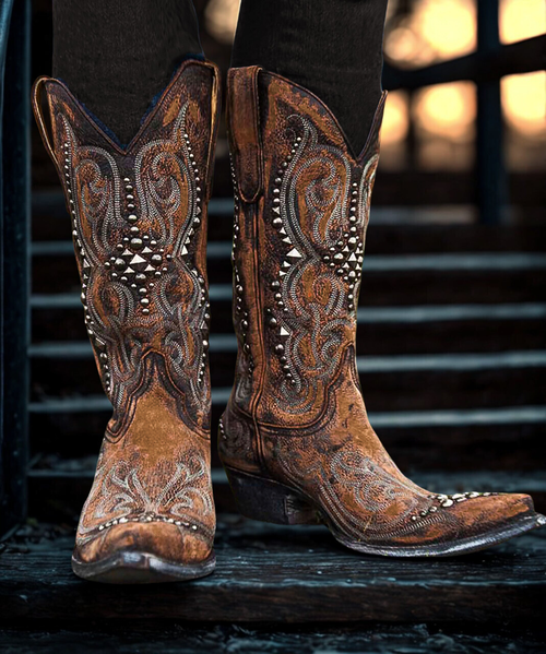 Old Gringo Dolce Stud – Shedron Leather
Classic Western soul meets contemporary edge in the Dolce Stud boot by Old Gringo. Handcrafted from rich, distressed shedron leather, this striking style features artistic stitching and carefully placed silver stud accents that add just the right amount of sparkle and sass.

With a timeless silhouette and modern attitude, the Dolce Stud embodies everything we love about Old Gringo — heritage craftsmanship, elevated design, and a bold cowgirl spirit. Whether you're dressing up denim or adding edge to a flowing skirt, this boot delivers effortless style with standout detail.