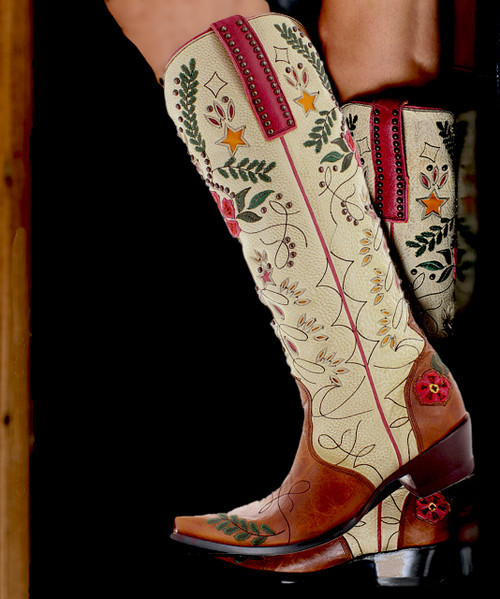 Our cowboy boots bond the time-honored art of handmade boots with a contemporary flair for fashion. Old Gringo Boots are unique, comfortable and made with the highest quality leathers. We add art to footwear using embroidery, Swarovski crystals, stud patterns, inlay/overlay, hand tooling, painting, and laser etching techniques. Every Old Gringo boot is the culmination of an over 250-step production process performed by our skilled craftsmen.

Color: Nut/Cream

Toe: 4Long 

Heel: 9964

Height: 18"