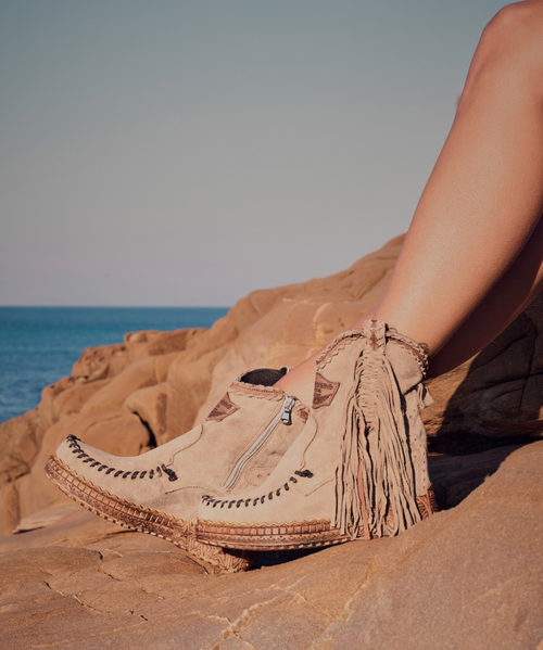 Our Vision moccasin-style boot features a plain over-the-knee bootleg, 2 3/4" hidden wedge, a cool ankle strap and the typical thick handmade stitching on the instep, distinctive feature of El Vaquero brand. Its simplicity gives the Vision boot a timeless elegance. Finished with the renowned Silverstone wash, a milestone of El Vaquero brand, that enhances every shade of leather, showcasing the most intense colors and making each boot unique in its kind.

Hidden wedge 2 3/4"
Vintage Treatment
100% Calf suede
Handmade Stitching
Hand-inserted details
Metal details 100% nickel-free
Rubber sole
Made in Italy