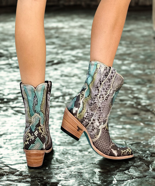 Add a bold touch of exotic flair to your wardrobe with these stunning ankle boots. Crafted from genuine python leather, the design showcases a captivating blue and green watercolor effect interwoven with natural snake patterns, creating a vibrant yet sophisticated look. Comfortable and eye-catching, they’re ideal for both casual outings and statement-making occasions.
This pattern can vary greatly, making each product made from python leather one-of-a-kind.
Shaft Height: 7
Heel Height: 2.25"
Toe Shape: Snip Toe
Signature Turquoise Soles
Easy in/out zipper Add a bold touch of exotic flair to your wardrobe with these stunning ankle boots. Crafted from genuine python leather, the design showcases a captivating blue and green watercolor effect interwoven with natural snake patterns, creating a vibrant yet sophisticated look. Comfortable and eye-catching, they’re ideal for both casual outings and statement-making occasions.
This pattern can vary greatly, making each product made from python leather one-of-a-kind.
Shaft Height: 7
Heel Height: 2.25"
Toe Shape: Snip Toe
Signature Turquoise Soles
Easy in/out zipper