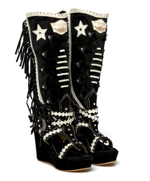 For those who love change, our Ariel is a perfect combination of boot and thong sandal characterized by decorations all over the shaft. The soft fringes on the sides give this model a feeling of movement, while the hand-inserted woven details give it that special, unique look that is so typical of our boots.

Featuring a 3.5" wedge heel and an elegant ankle belt-buckle closure, the mix of leather and natural cowhide make Ariel suitable for any occasion.