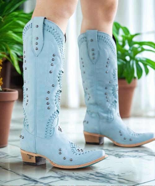 Meet Cossette in Powder Blue. She's as satisfyingly tactile as she is gorgeous. The supple, full grain leather lends itself perfectly to the intricate double helix of braiding that is sure to complete any look from casual to evening.

Shaft Height: 15"
Heel Height: 2"
Calf Circumference: 16"
Ankle Circumference: 13"
Toe Shape: Snip
Signature Turquoise Soles