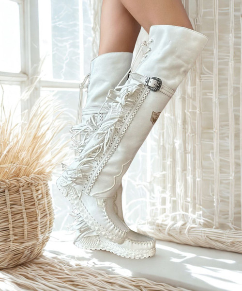 The Coleen boot is a must-have in the wardrobe of every loyal customer of El Vaquero brand. This double layered over-the-knee boot showcases the brand\'s signature handmade stitching on the instep, exquisite fringe detailing and an elegant lace-up back. The exceptional Silverstone ageing technique brings out the most intense colors, ensuring that each boot stands out with a unique vibrancy. The meticulous craftsmanship behind Silverstone showcases the depth and richness of hues, making every pair a one-of-a-kind masterpiece.

Hidden wedge 2 3/4"

Vintage Treatment
100% Calf suede 
Handmade Stitching
Metal details 100% nickel-free
Rubber sole