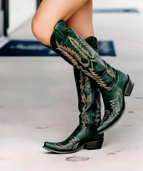 Old Gringo Mayra Boots – Vesuvio Chocolate
Daring. Dramatic. Drop-dead gorgeous.
The Old Gringo Mayra Boots in vesuvio chocolate are the ultimate showstoppers for the modern women with bold taste. Crafted from the softest distressed leather, these boots hug your legs with an 18-inch tall shaft, creating a sleek, leg-lengthening silhouette that’s made to turn heads.

What sets them apart? The rich chocolate leather is adorned with contrasting embroidery in denim-blue thread, giving the design a laid-back, luxe attitude. A sharp snip toe, interior side zippers, and a comfortable 1¾" walking heel complete the look — making these boots as wearable as they are unforgettable.

Whether you're dressing for a night out or making a statement on the daily, the Mayra in Chocolate is your fearless, fashionable go-to.

Details:

Shaft Height: 18"

Shaft Opening: 15.5" circumference

Heel: 1.75" Walking Heel

Toe: Snip

Leather: Vesuvio chocolate distressed leather

Embroidery: Blue jean thread on shaft

Closure: Interior side zippers

Fit: Standard width
