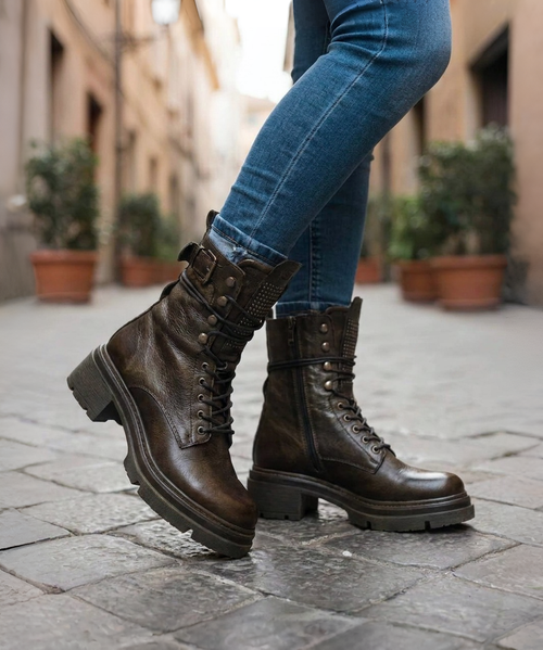 The Clint Boot by El Vaquero is a striking over-the-knee silhouette that blends refined craftsmanship with effortless summer elegance. Distinguished by a sleek ankle strap and beautifully detailed leather accents along the shaft, this boot delivers unmistakable style with a soft, artisanal feel.

Crafted in Italy from a unique combination of luxurious calfskin suede and fine natural linen, Clint offers a fresh, lightweight construction that’s perfect for warm-weather styling. The subtle 7 cm internal wedge provides comfortable lift without compromising ease, while the vintage treatment adds character and depth to every pair.

Finished with handcrafted stitching, nickel-free metal details, and a durable rubber sole, the Clint boot is designed for confident, all-day wear. Elegant yet relaxed, it pairs effortlessly with flowy dresses, tailored shorts, or layered summer looks.

Details:

Over-the-knee boot

Internal wedge: 7 cm

Vintage treatment

100% calfskin suede and natural linen

Handcrafted stitching

Nickel-free metal details

Rubber sole

Made in Italy