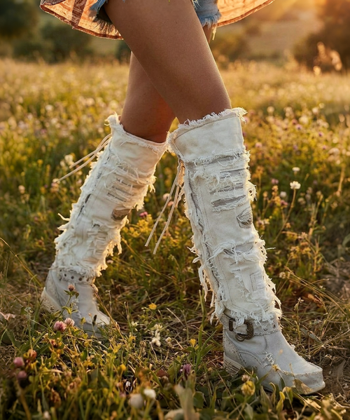 The Clint Boot by El Vaquero is a striking over-the-knee silhouette that blends refined craftsmanship with effortless summer elegance. Distinguished by a sleek ankle strap and beautifully detailed leather accents along the shaft, this boot delivers unmistakable style with a soft, artisanal feel.

Crafted in Italy from a unique combination of luxurious calfskin suede and fine natural linen, Clint offers a fresh, lightweight construction that’s perfect for warm-weather styling. The subtle 7 cm internal wedge provides comfortable lift without compromising ease, while the vintage treatment adds character and depth to every pair.

Finished with handcrafted stitching, nickel-free metal details, and a durable rubber sole, the Clint boot is designed for confident, all-day wear. Elegant yet relaxed, it pairs effortlessly with flowy dresses, tailored shorts, or layered summer looks.

Details:

Over-the-knee boot

Internal wedge: 7 cm

Vintage treatment

100% calfskin suede and natural linen

Handcrafted stitching

Nickel-free metal details

Rubber sole

Made in Italy