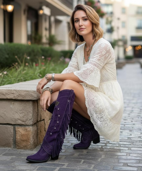 Katherine Boot in Royal Purple Deep Violet Silverstone
Make a bold statement with the Katherine Boot, where every detail tells a story. Crafted in Italy with masterful precision, this western-inspired boot features:

A 2 3/4" leather-stacked heel for the perfect blend of height and comfort

Striking Sintino-style pointed toe

17" tall silhouette that elongates the leg and commands attention

Handmade stitching and hand-inserted details that showcase artisanal craftsmanship

Intricate leather carvings and patterns around the ankle and shaft

Fringed side accents for a touch of movement and flair

100% nickel-free metal elements, adding shine without compromising comfort

A vintage finish that brings rich, multi-dimensional shades to the Royal Purple Deep Violet Silverstone leather

From festivals to faraway escapes, the Katherine Boot is made for dreamers who walk their own path.