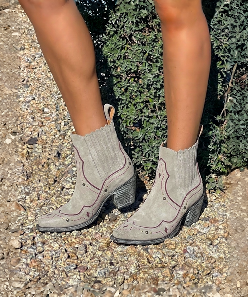 The Clint Boot by El Vaquero is a striking over-the-knee silhouette that blends refined craftsmanship with effortless summer elegance. Distinguished by a sleek ankle strap and beautifully detailed leather accents along the shaft, this boot delivers unmistakable style with a soft, artisanal feel.

Crafted in Italy from a unique combination of luxurious calfskin suede and fine natural linen, Clint offers a fresh, lightweight construction that’s perfect for warm-weather styling. The subtle 7 cm internal wedge provides comfortable lift without compromising ease, while the vintage treatment adds character and depth to every pair.

Finished with handcrafted stitching, nickel-free metal details, and a durable rubber sole, the Clint boot is designed for confident, all-day wear. Elegant yet relaxed, it pairs effortlessly with flowy dresses, tailored shorts, or layered summer looks.

Details:

Over-the-knee boot

Internal wedge: 7 cm

Vintage treatment

100% calfskin suede and natural linen

Handcrafted stitching

Nickel-free metal details

Rubber sole

Made in Italy