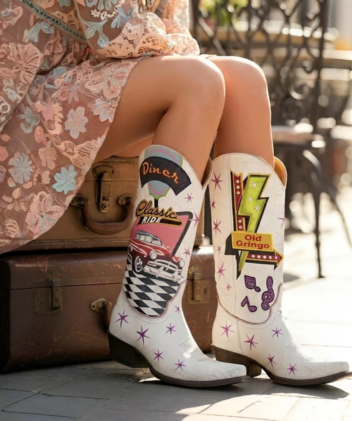 Old Gringo – Austin Boots | Pink/Purple

This is Austin—and we sure do love her. ? New from Old Gringo Boots, this joyful standout is bursting with country-western charm and fearless color. Rich mulberry pink and purple leathers set the stage for an explosion of details, accented with pops of turquoise and yellow for a look that’s bold, playful, and undeniably fun.

Stars, hearts, arrows, florals, gleaming studs—Austin has it all. Finished with full side zippers for easy on-and-off and designed in a flattering mid-calf silhouette, she’s effortlessly wearable year-round. Whether styled with denim, dresses, or cutoffs, these boots deliver the perfect cowgirl statement every time.

Measurements:

Shaft Height: 12"

Shaft Opening: 13.5" circumference

Heel Height: 1 ¾"

Toe: Snip

Bright, spirited, and full of personality—Austin is western style with a wink. ?✨