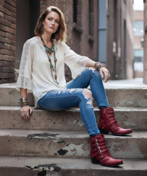 The distressed Vesuvio red leather, buckle accents, and silver stud work is an over-the-top fashion statement. These beauties are finished off with interior side zippers, a snip toe, and easy walking heel.