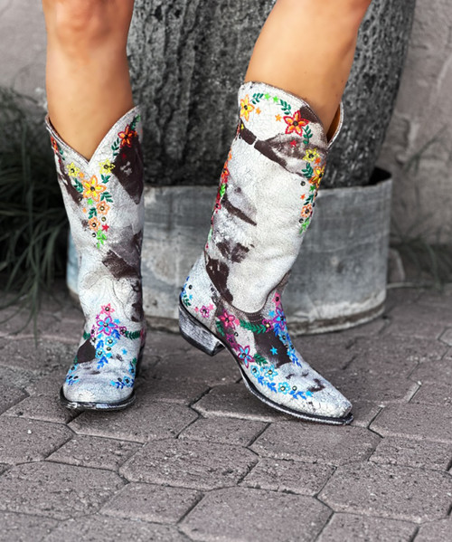 The Old Gringo Sozey Crystal Boots are made from soft brass brown vintage leather. The dark distressing mixes beautifully with the light brown, making these boots the ideal match for any outfit. The Sozey Boots have been decorated with multi color floral embroidery and small crystal stud accents throughout. The funky flowers are etched in bright colors like red, pink, green, teal, orange, and blue. These Old Gringo Boots would be perfect to wear during the Spring and Summer with a Sundress, or you can let them carry you into Fall and Winter with Jeans or Leggings. The boot shaft measures 13 inches, she ends in a pointed snip toe, and comes with boot pulls for easy pull on. Let these flirty, colorful Sozey boots, handcrafted by Old Gringo, be your best new accessory.