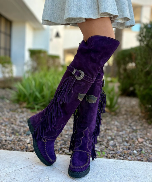 El Vaquero – Coleen Boot

The Icon, Reimagined.

A true staple in the wardrobe of every El Vaquero devotee, the Coleen boot is the embodiment of the brand’s free-spirited heritage and artisanal mastery. With its striking over-the-knee silhouette, signature double-layered construction, and intricate handcrafted details, Coleen is both timeless and bold.

This boot features handmade stitching, cascading fringe detailing, and an elegant lace-up back for a customized fit and dramatic flair. Crafted from 100% premium calf leather and treated with El Vaquero’s renowned Silverstone vintage wash, each pair boasts rich, intense color variations—making every boot entirely unique.

Details:

7 cm hidden wedge for subtle height and day-long comfort

Signature Silverstone vintage treatment for unique color depth

100% calf leather – soft, structured, and made to age beautifully

Handmade stitching and hand-inserted accents throughout

Nickel-free metal hardware for skin-safe wear

Rubber sole for grip and flexibility

Proudly made in Italy