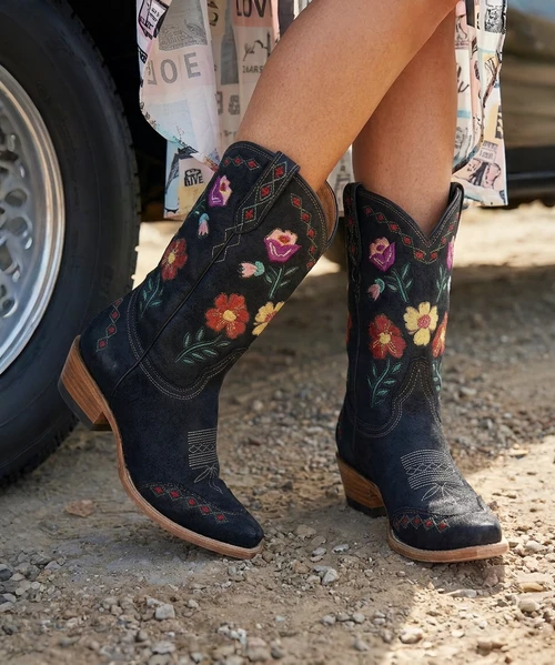 Meet the Punky Cowboy Boot by Double D Ranch for Old Gringo—a bold fusion of classic western craftsmanship and fearless, feminine flair.

Crafted from premium black cowhide leather, this standout style features vibrant embroidered floral detailing that pops beautifully against the rich dark base, bringing a fresh, artistic twist to a timeless silhouette. The intricate stitching adds dimension, color, and personality—perfect for those who love a little edge with their western roots.

Designed with a sleek 4Long toe and a flattering 9964 heel, this boot delivers that iconic cowgirl shape while remaining comfortable and wearable from day to night. The 10” shaft height hits at just the right spot, making it easy to style with dresses, denim, or statement looks.

Part of the DDR 09 ‘25 collection, this model (DDL1082-2) embodies the spirit of Double D Ranch—where heritage meets individuality.

Details:

Double D Ranch for Old Gringo

Model: DDL1082-2

Color: Black

Premium cowhide leather

Bright embroidered floral detailing

Toe: 4Long

Heel: 9964

Shaft Height: 10”

A little rebellious. A little romantic. Completely unforgettable.