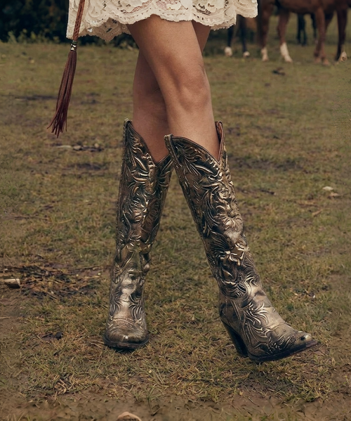 Step into timeless Western elegance with the Old Gringo Classics Collection – Model L147-10 ?✨

Rendered in a rich Dark Natural leather, this boot embodies that perfectly worn-in, heritage feel Old Gringo is known for. The tone is warm, versatile, and effortlessly pairs with everything from denim to flowing dresses, making it a true wardrobe staple.

The 13-inch shaft offers a classic, flattering silhouette that elongates the leg, while the Karine toe delivers a refined, slightly tapered shape—balancing tradition with a touch of modern femininity. Finished with a heel height of 0, this style is all about comfort without compromising on style, making it ideal for all-day wear.

Whether you're building your everyday Western lineup or investing in a forever piece, this boot is understated, authentic, and endlessly wearable.

Details:

Model: L147-10
Collection: Classics
Color: Dark Natural
Shaft Height: 13"
Toe: Karine
Heel: 0

A true classic—crafted to last, styled to live in ?