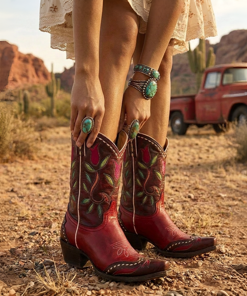 Double D Ranch Tulip Time Boot

A playful pop of color with a retro soul.

Step back into the carefree charm of the Atomic Ranch era with the Tulip Time Boot by Double D Ranch. One of the season's most eye-catching shorties, this whimsical boot blends mid-century modern inspiration with unmistakable Western flair. Rich shades of tan and red come together in stunning floral inlays, while contrast leather overlays, a two-toned toe box, and decorative leather lacing create a look that's equal parts vintage and vibrant.

The 7-inch shaft makes this boot incredibly versatile, offering just the right amount of statement style whether paired with cropped denim, a flowing prairie dress, or a twirl-worthy swing skirt. Finished with Double D Ranch's comfortable walking heel and signature long toe silhouette, Tulip Time is designed for women who aren't afraid to stand out.

Charming, feminine, and full of personality, this boot delivers a fresh burst of color and artistry to any wardrobe.

Features
Rich tan and red leather construction
Intricate floral inlay and overlay details
Two-tone toe box design
Contrast leather lacing accents
7" shaft height
Comfortable walking heel
Signature long toe silhouette
Handcrafted Double D Ranch artistry