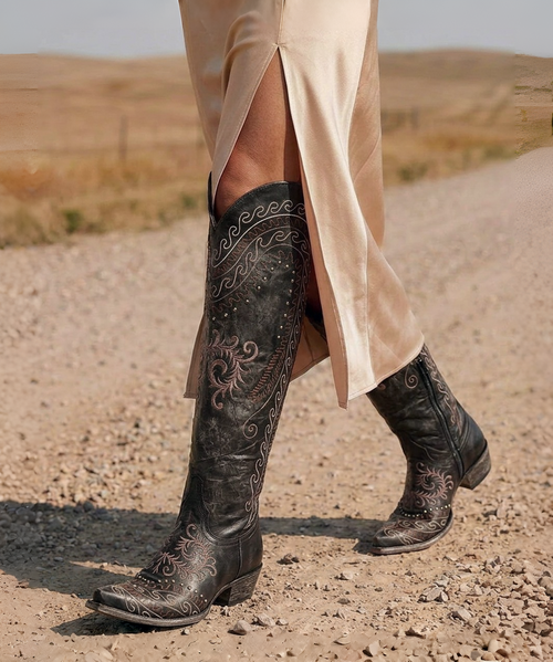  

The ultimate showstopper has arrived.

 

Turn every sidewalk into your own runway with the breathtaking Old Gringo Gaban Boots. These stunning tall boots are handcrafted in León, Mexico, and feature vibrant, artistic embroidery that transforms a classic western silhouette into a true wearable masterpiece.

 

The elegant 18-inch shaft sits just below the knee, while the colorful embroidered design creates a bold, fashion-forward statement from every angle. A flattering snip toe, comfortable 1¾-inch heel, and convenient inside partial zipper make the Gaban as easy to wear as it is beautiful.

 

Whether you're dressing up for the holidays, a concert, girls' night out, date night, or simply want to make an unforgettable entrance, these aren't just cowgirl boots—they're unforgettable fashion boots that are guaranteed to turn heads.

 

If you're looking for a pair of boots that will have everyone asking, "Where did you get those?", you've found them.