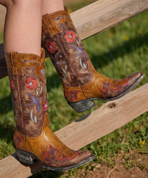 Old Gringo Golondrita Boots
Free-spirited, fearless, and full of vintage soul.

The Old Gringo Golondrita is a celebration of bohemian beauty and Western charm, wrapped into one unforgettable pair of boots. Crafted from a vibrant patchwork of richly colored leathers, these artisan beauties feature whimsical inlay designs including soaring birds, hearts, flowers, arrows, and diamond motifs that tell a story of adventure, freedom, and individuality.

Set on Old Gringo's iconic cowgirl silhouette, the Golondrita features a flattering mid-calf shaft, comfortable walking heel, and classic snip toe that effortlessly balances style and wearability. Wingtip-inspired detailing and interior pull tabs complete the look, while the kaleidoscope of colors ensures these boots become the focal point of every outfit.

Whether paired with a flowing sundress, vintage denim, or your favorite bohemian layers, the Golondrita brings a playful, retro-inspired spirit that's impossible to ignore.

Features
Handcrafted leather construction
Multicolor artisan inlay design
Bird, heart, flower, arrow, and diamond motifs
Mid-calf shaft height
Comfortable snip toe
Easy walking heel
Interior pull tabs
Signature Old Gringo craftsmanship
Measurements:

Shaft Height - 12"
Shaft Opening - 13.5" circum. (Will accommodate calf up to 16")
Heel Height - 1 & 3/4"
Toe - Snip
Standard Width