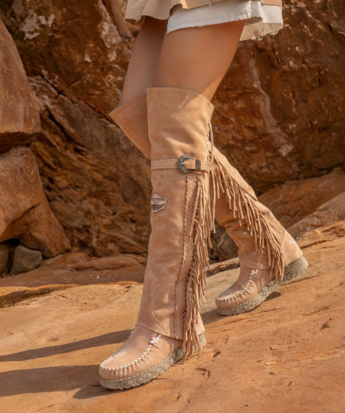 The Coleen boot is a must-have in the wardrobe of every fan of the El Vaquero brand. This incredible boot features a double upper above the knee, typical handcrafted stitching, beautiful side fringes and an elegant lacing on the back. The new Goldenwyrm combination is an absolute novelty: a viper-print vegetable calfskin with hand-padded gold that creates an incredibly revolutionary effect.

Internal wedge 2 3/4"
Viper print vegetable calf
Hand gold infill
Handcrafted stitching
Metallic details 100% nickel free
Leather details
Rubber sole
Made in Italy