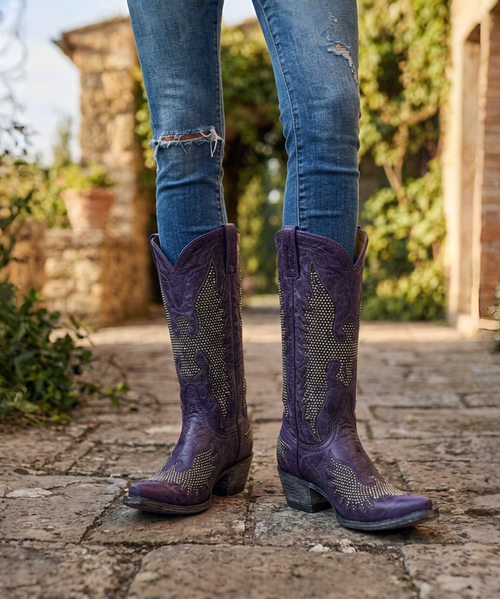 Features
Handcrafted in León, Mexico
Rich distressed purple leather throughout
Thousands of individually applied antique nickel studs
Signature Iron Eagle antique nickel inlays on the foot and shaft
Comfortable walking heel
Distressed black leather sole and heel finish
Leather lining and leather outsole
Collectible limited-production Old Gringo design
Measurements
Shaft Height: 13"
Heel Height: 1 3/4" walking heel
Toe: 4L Snip
Width: Standard (B)
Whether you're a longtime Old Gringo collector or searching for a boot unlike anything else in your closet, the Purple Biker Iron Eagle is the definition of bold Western luxury. Rare, unforgettable, and handcrafted to perfection, this is the kind of boot that becomes the centerpiece of your collection—and one you'll treasure for years to come.