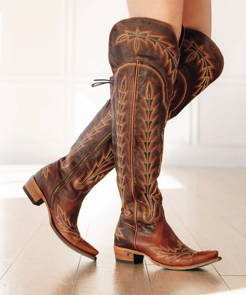 Bold, sleek, and undeniably sexy, the Lexington OTK Corset in Cognac leather is the ultimate women’s over-the-knee cowboy boot. Clean lines, classic stitching, and a dramatic silhouette make this an instant power move.

Designed with a functional corset back and inside zipper for easy wear, this tall cowgirl boot offers a customizable fit with timeless edge—anchored by Lane Boots’ iconic turquoise soles.

Heel Height: 1.75"
Shaft Height varies by size:
22.9" Size 5
24.25" Size 8
24.8" Size 11
Ankle Circumference: 11"
Calf Size:  15"-17" Corset Standard Laces (included)
Calf Size:  Up to 19.25" Extra Long Corset Laces (available separately)
Toe Shape: Snip
Signature Turquoise Soles
