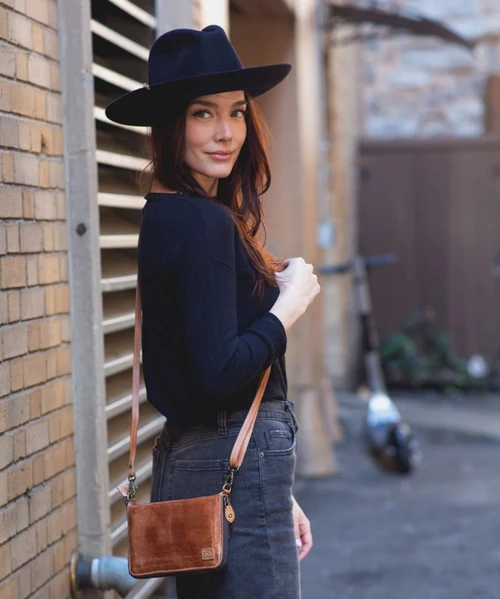 Templeton II is the kind of piece that keeps up. Designed as a 3-in-1 essential, it moves effortlessly from wallet to clutch to crossbody with the simple addition of a strap. Crafted from full-grain, vegetable-tanned leather with rich hand-applied finishes, it carries depth and character in every detail. A smooth zip-around closure offers secure, easy access, opening to interior organization that keeps cards, cash, and essentials neatly in place. Streamlined, versatile, and ready at a moment’s notice, Templeton II makes light travel feel like second nature.
