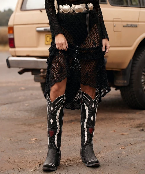 That's a much better name for these boots! ❤️? Old Gringo Arrow to the Heart perfectly captures the bold white arrow-inspired detailing and romantic red heart accents. I'd make the name central to the Boot Junky product description.

# Old Gringo Arrow to the Heart 18" Leather Western Boots – Black

**Straight to the heart, cowgirl!**

Some boots turn heads. Others steal hearts. Meet **Arrow to the Heart by Old Gringo**, an electrifying blend of Western romance, rebellious spirit, and unmistakable attitude.

Crafted in beautifully distressed black leather, these striking 18" tall beauties feature dramatic white arrow-inspired leather appliqués that sweep down the shafts, creating a bold contrast against the rich, dark leather. Deep red hearts add just the right touch of romance, while crisp white piping outlines the intricate Western detailing for a look that's both edgy and irresistibly feminine.

The dramatic knee-high silhouette makes a statement all its own, complemented by sharply pointed Western toes, decorative stitching, and classic Western heels. Convenient interior side zippers make these tall beauties easier to slip on and off.

From concert nights and country festivals to date nights and everything in between, Arrow to the Heart brings a little danger, a little romance, and a whole lot of cowgirl confidence to your wardrobe.

Pair them with distressed denim, a flowing boho dress, or your favorite little black mini. One thing's certain—these aren't boots that fade into the background!

**Details We Love:**

- Old Gringo Arrow to the Heart design
- Dramatic 18" tall Western silhouette
- Distressed black leather
- Contrasting white arrow-inspired leather appliqués
- Deep red heart accents
- Crisp white piping and decorative Western stitching
- Sharply pointed Western toes
- Classic Western heels
- Convenient interior side zippers
- Bold, vintage-inspired Western styling

**Love at first sight? More like an arrow straight to the heart!** ❤️


