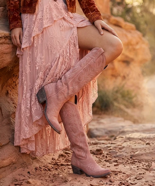Boots are made for walking AND looking amazing, and the Old Gringo Mayra Boots are SO on trend. These aren't just cowgirl boots; these are fabulous fashion boots. Handcrafted in Leon, Mexico with gorgeous Soft Pink brushed leather and accented with cream embroidery. We love the tall, 18" silhouette and pointed snip toe of the Mayra Boots. Whether you rock them for Spring & Summer or for a fabulous date night, we know you will look AMAZING and turning heads in the Mayra Soft Pink Boots!


* Shaft Height - 18"
* Shaft Opening - 13.5" circum.
* Heel Height - 1 & 3/4" 
* Toe - Snip
* Standard Width