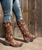 We just can't get enough of the Old Gringo Letty. The midnight black and buttercup gold boot shaft mixes beautifully with the vesuvio pink leather accents. The Letty boot was made for ladies looking to make a bold fashion forward statement. The floral designs on the toe are beautiful and the heart shaped embroidery on either side of the boot shaft gives it a sassy finish. Add the Old Gringo Letty boot to your collection...I can promise you won't be sorry!

Toe - Snip

Heel - 9964 Walking Heel

Vesuvio Black leather foot 

Buttercup leather shaft

red floral inlay on foot

pink leather collar

Leather upper, lining, insole, and outsole

stacked leather western heel

single stitch welt

13 in shaft height