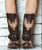 Old Gringo Biker Eagle is a funky pair of chocolate brown and bone distressed leather biker boots decorated with eagle designs and harness accents. The heel and rounded toe are very comfortable and the biker look becomes complete with the large buckle at the ankle. 