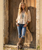 This is a **bold, highly embellished Western statement boot** that blends rugged cowgirl attitude with intricate Southwestern artistry. The rich **espresso-brown leather** is beautifully contrasted by **metallic brass and antique-gold accents**, creating a warm, aged, almost heirloom-inspired finish.

The shaft is covered in **ornate appliqué detailing, dimensional crosses, floral motifs, silver-toned studs, conchos, and hand-stitched embroidery**, giving the boot an incredible amount of texture and depth. The dramatic metallic brass overlays at the upper shaft and around the foot add a distinctive vintage-meets-rebel character.

One of the most eye-catching details is the **leather lace-up corset-style back**, which runs the length of the shaft and adds both visual interest and an adjustable element to the fit. The decorative side panels and embellished pull tabs continue the elaborate detailing from top to bottom.

The **snip toe and 1¾-inch western heel** give the boot a classic, flattering silhouette, while the combination of chocolate leather and metallic brass makes it surprisingly versatile—it would look incredible with denim, dresses, skirts, or layered boho pieces.

### Product description

**Double D Ranch Ammunition Boots – Metallic Brass & Espresso**

A true collector-worthy statement boot, the **Double D Ranch Ammunition** is where Western artistry meets rebellious cowgirl style. Rich espresso-brown leather is layered with shimmering metallic brass accents, intricate embroidery, dimensional crosses, ornate appliqués, antique-inspired studs, and dramatic Southwestern detailing.

The standout **corset-style leather lacing along the back of the shaft** adds an unexpected touch of attitude while complementing the boot’s beautifully embellished silhouette. Every inch is designed to make an impression, from the elaborate shaft detailing to the intricately decorated foot and classic snip toe.

These are not everyday Western boots—they're **wearable works of art** made for the woman who loves her boots to have personality, presence, and a little bit of rebellion. ?✨?

**Details:**

* **Shaft Height:** 16"
* **Shaft Opening:** 14"
* **Heel Height:** 1¾"
* **Toe:** Snip
* **Width:** Standard
* **Color:** Metallic Brass & Espresso Brown
* **Back:** Corset-style leather lacing
* **Style:** Western / Boho / Statement Boot
