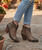 The Clint Boot by El Vaquero is a striking over-the-knee silhouette that blends refined craftsmanship with effortless summer elegance. Distinguished by a sleek ankle strap and beautifully detailed leather accents along the shaft, this boot delivers unmistakable style with a soft, artisanal feel.

Crafted in Italy from a unique combination of luxurious calfskin suede and fine natural linen, Clint offers a fresh, lightweight construction that’s perfect for warm-weather styling. The subtle 7 cm internal wedge provides comfortable lift without compromising ease, while the vintage treatment adds character and depth to every pair.

Finished with handcrafted stitching, nickel-free metal details, and a durable rubber sole, the Clint boot is designed for confident, all-day wear. Elegant yet relaxed, it pairs effortlessly with flowy dresses, tailored shorts, or layered summer looks.

Details:

Over-the-knee boot

Internal wedge: 7 cm

Vintage treatment

100% calfskin suede and natural linen

Handcrafted stitching

Nickel-free metal details

Rubber sole

Made in Italy