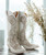 Another stunning pair of Old Gringo boots—the Migissi! These boots are a gorgeous blend of classy and country, making them an ideal match for any stylish cowgirl or someone looking for a unique touch to their wardrobe.

The laser-cut floral patterns on the taupe and bone leather give them a sophisticated yet rustic vibe. They have that perfect balance of elegance and edge that makes them versatile for different occasions.

 

The 13" shaft height and 1 3/4" walking heel make them both stylish and comfortable enough to wear for extended periods. The snip toe adds a traditional western touch, but it still feels fresh and modern with the laser-cut design. 

 

If you're considering these for a wedding or special event, they’d definitely be an unforgettable choice. Plus, the combination of taupe and bone is so neutral, they'd match with almost any color scheme.

 

Are you leaning towards these boots for a particular event, or are you just loving the style?

Measurements:

Shaft Height - 13"
Heel - 9964
Toe - Snip