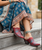 Floral embroidery in blue against distressed red leather with silver studs makes this mule one of our best-sellers. Pair these with your favorite blue jeans or a dress for a free-spirited look. Cushioned leather footbed makes it comfortable on every step. 