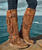 Jackie is our cowboy’ style wedged moccasin. Warm and congenial, this creation is particularly embellished with a series of fringes on both side and a double buckle straps. Leather decorations runs down from the boots to meet the hand-made raw color stitches. After our special vintage waxy treatment Jackie is ready to walk free and travel the world. Available in a timeless earthy color mou Carmel.

Internal Wedged moccasin - 2 3/4" Hidden Heel with a 1.5" Wedge
Leather logo tag
Stitching details
Unlined
Rubber sole
Made in Italy
Composition: 100% Calf