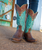 Bold and unapologetic, the Straight as an Arrow western boot makes a striking statement in a rich Oryx turquoise hue. Finished with eye-catching riveted detailing, this standout style blends classic Western craftsmanship with modern edge.

Designed with a sleek 4Long toe and grounded by the dependable 9964 heel, this boot offers both a sharp silhouette and all-day wearability. The 13" shaft height creates a versatile profile that pairs effortlessly with denim, dresses, or layered looks. Confident, distinctive, and right on target—this boot is made for those who like their Western style straight as an arrow.

Details:

Style Name: Straight as an Arrow

Color: Oryx

Toe: 4Long

Heel: 9964